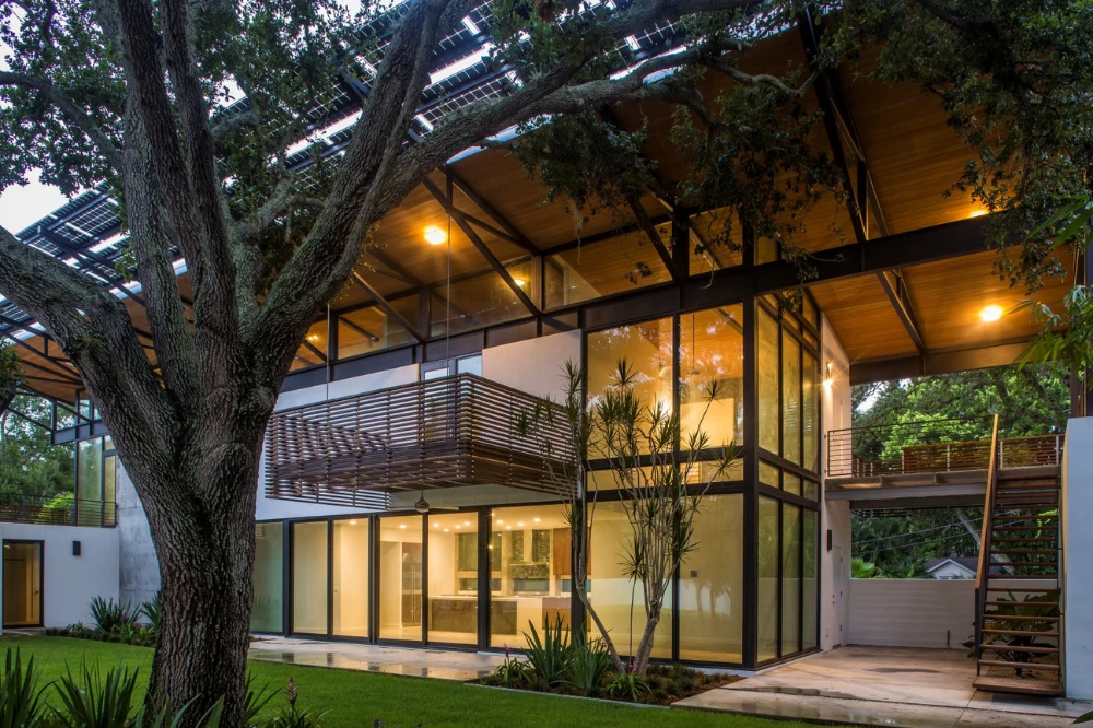 Modern courtyard house with deep roof overhangs shading a terrace