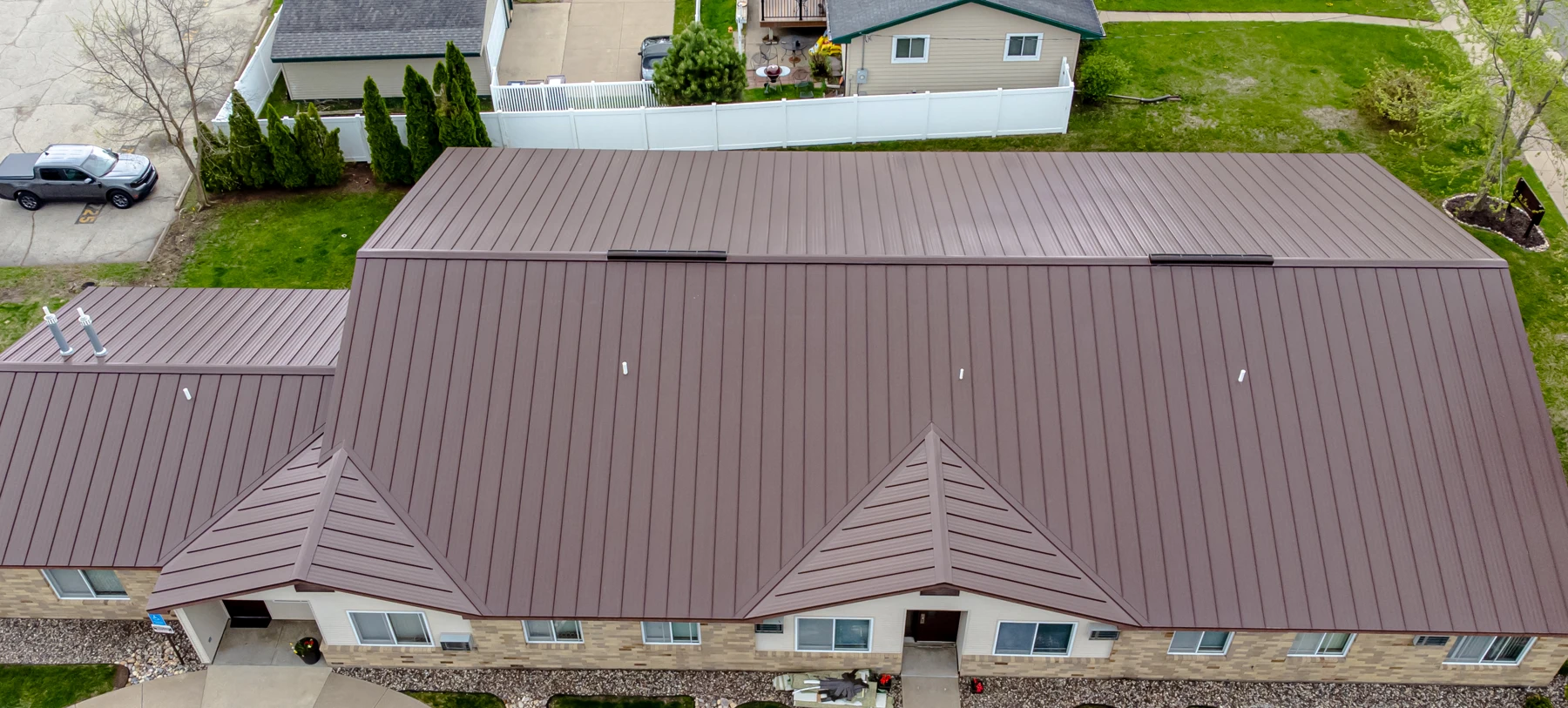 Standing-seam metal roof panels running to the ridge